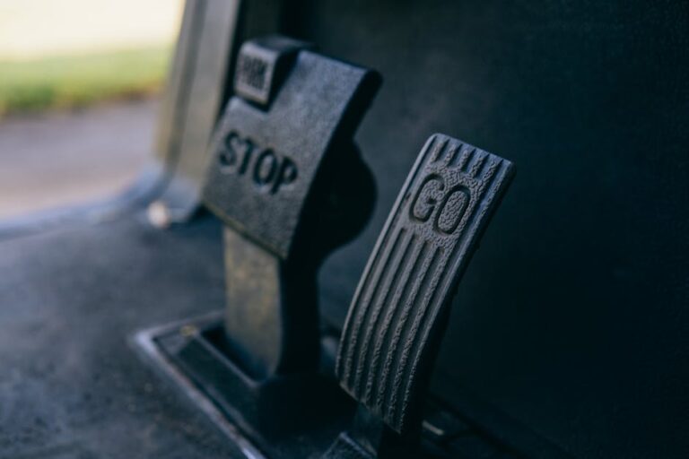 Close-up photograph of Go and Stop pedals in a vehicle, highlighting texture.