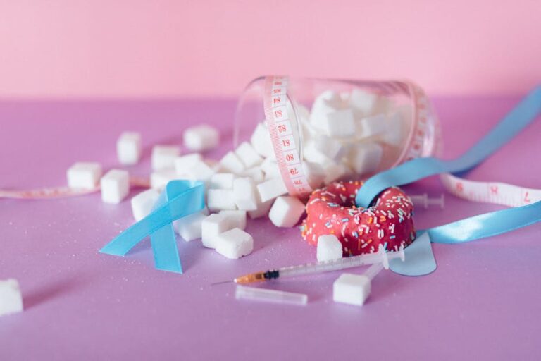 Pink and blue theme on diabetes awareness with sugar cubes and medical ribbons.