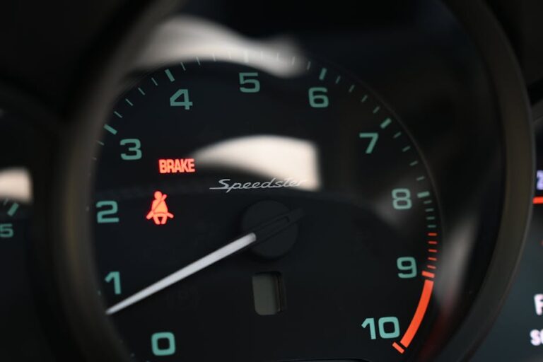 Detailed view of a car speedometer showing brake and seatbelt warnings.