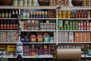 A vintage grocery store shelf filled with retro products and packaging from various brands.