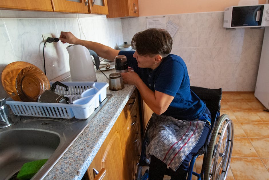 A woman in a wheelchair prepares coffee in a cozy kitchen setting.