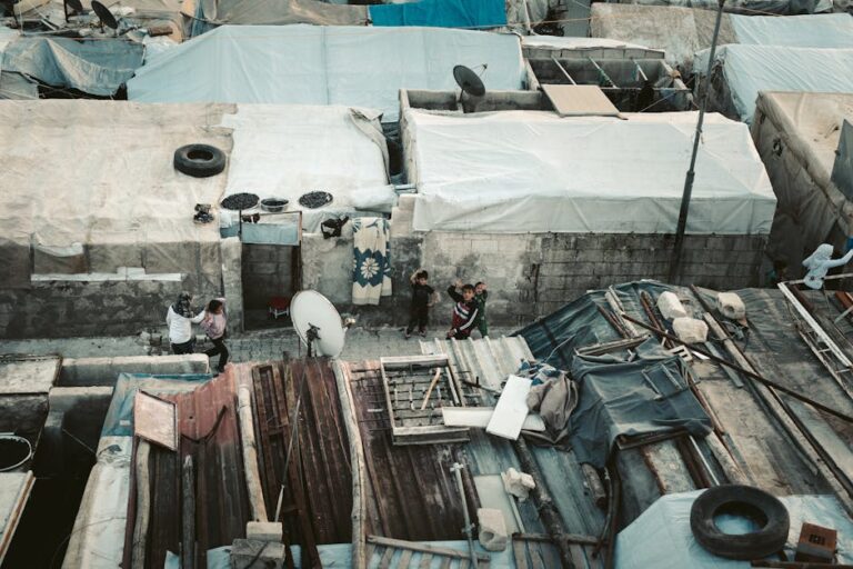 Aerial image showing rooftops and people in a Syrian refugee camp.
