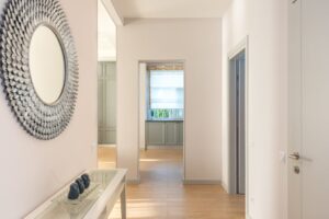 Minimalist interior hallway with wall art and natural light. Modern design.