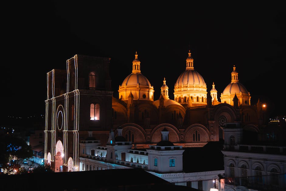 Stunning nighttime view of the illuminated Cuenca Cathedral, showcasing its iconic architecture under a starlit sky.