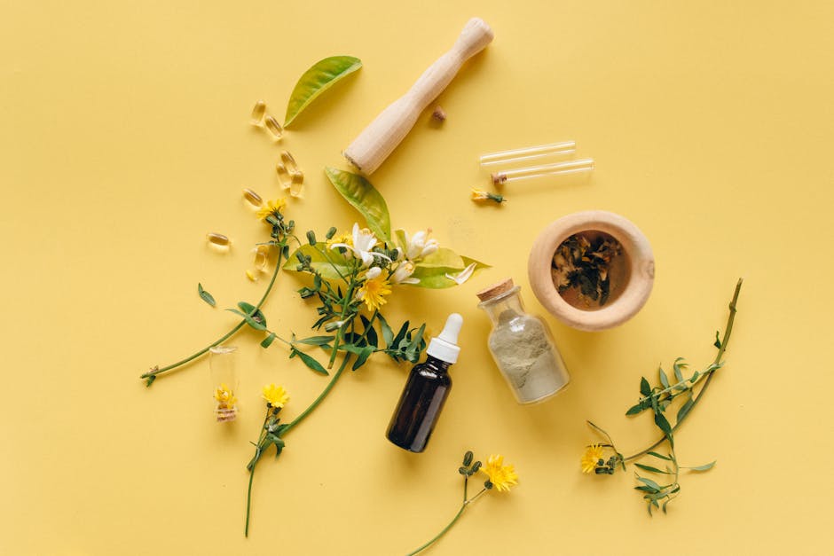 A flat lay of herbal medicines and plants on a yellow background for natural healing.