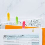 Colorful tabs organizing tax documents for easy filing and reference.