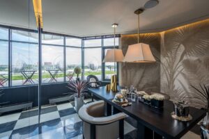 Elegant office space with modern design, featuring luxurious furniture and a scenic glass wall view.