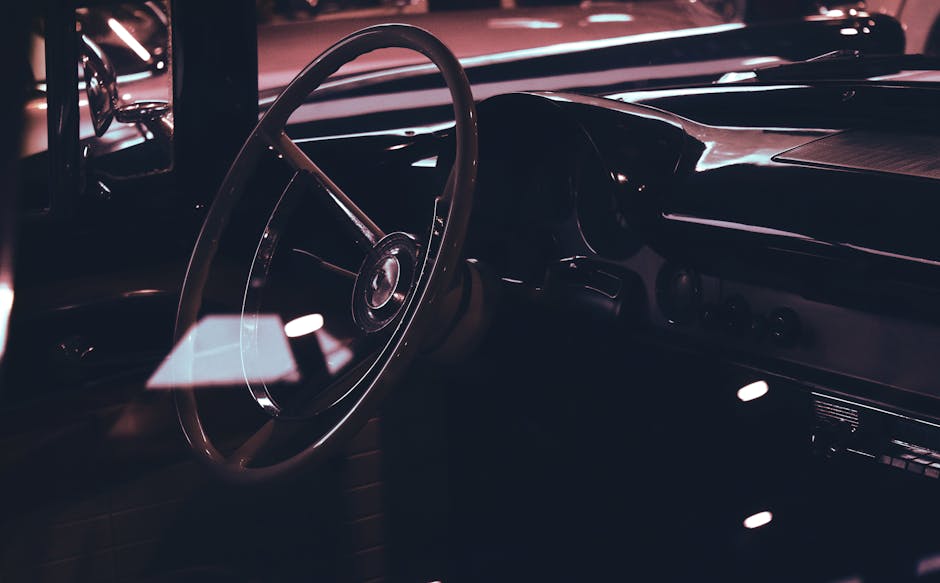 Explore the luxurious design of a classic car interior, highlighted by the vintage steering wheel.