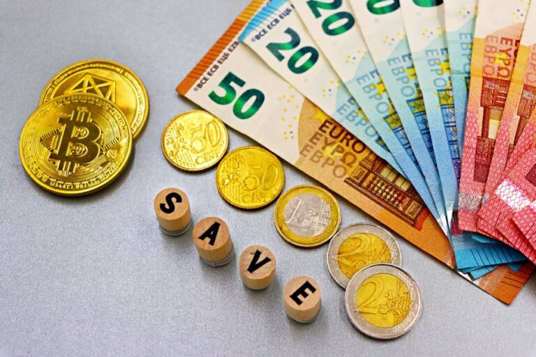 Euro banknotes and Bitcoin coins arranged with 'save' text for finance concept.